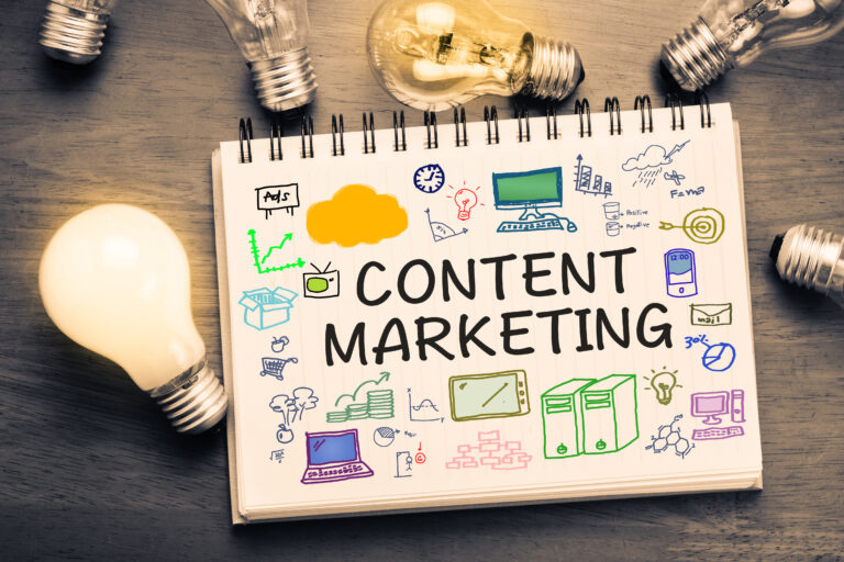 Content Marketing and drawing on notebook with glowing light bulbs